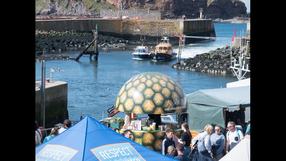 Eyemouth RNLI lifeboat tows boat into Eyemouth harbour watched by Gala Day crowds.