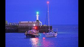 Lowestoft RNLI Relief lifeboat Eric's Legend tows the stranded yacht into Lowestoft