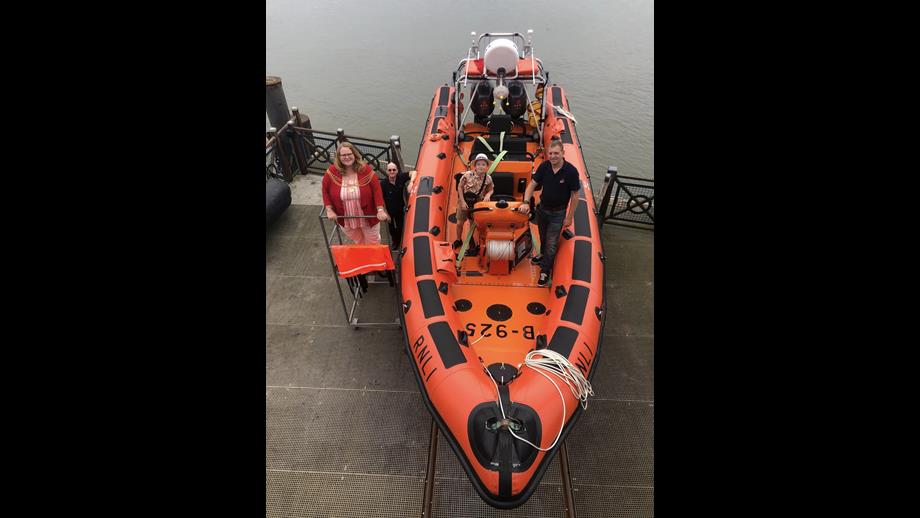 Mayor on the left of orange lifeboat with volunteers 
