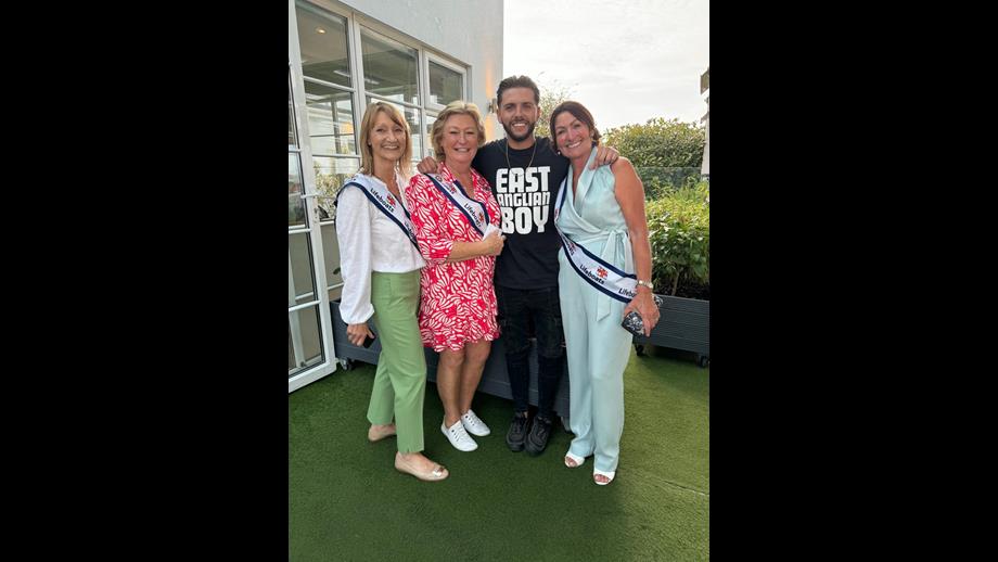 A group photo of two women, a man and another women on the right