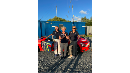 Niamh McCutcheon, Christine O'Malley and Laura Clarke standing in front of the Porsche 911