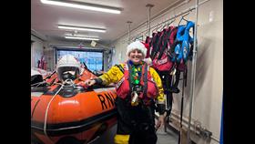 Rachel - Crew at Hastings RNLI - Standing in front of their D-class lifeboat