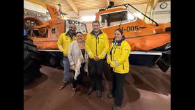L-R hovercraft pilot Paul Sherratt, Becky Hughes, hovercraft commander Andy Dodd, and hovercraft crew member Emily Jones.