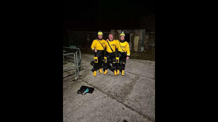 Crew members Aonghus O hIarnain, Declan Brannigan and Ronan MacGiollapharaic standing on Cill Einne Pier after rescuing the four dolphins