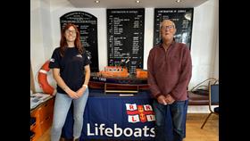 Holly Turner and Alan Reynolds at the RNLI shop with the lifeboat