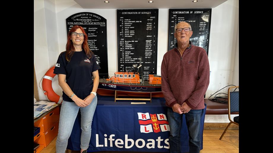 Holly Turner and Alan Reynolds at the RNLI shop with the lifeboat