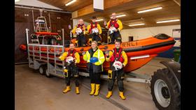 Carrybridge RNLI’s newest volunteers. Pictured in the lifeboat from left are Eamonn McManus, Matthew Maguire and Ronnie Heslop. Standing in front are from left are Richard Neely, Emma Burton and Lee Morrison. Missing are Douglas McFarland, Ciaran Smyth and Stephen Somerville. Photo Credit: Stephen Scott.