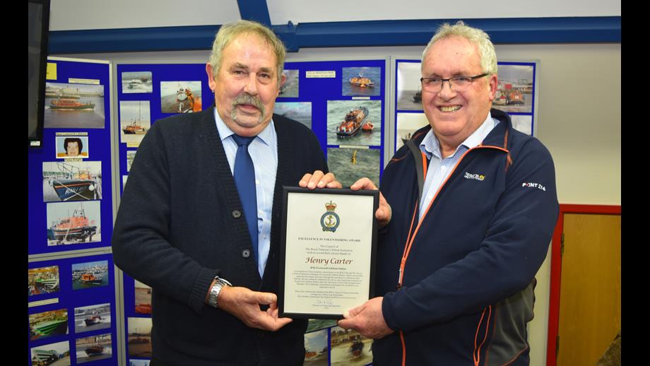 Henry Carter receives his Excellence in Volunteering Award from Richard Musgrove