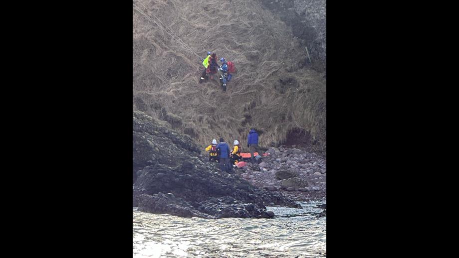 Volunteers from RNLI and coastguard provide assistance to walkers that had fallen at cliffs south of Stonehaven