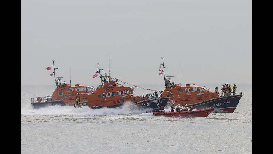 four lifeboats heading out to sea