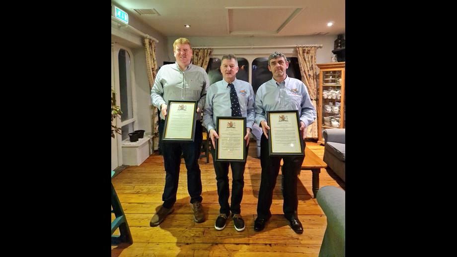 RNLI Helm Brendan Cottrell, Coxswain Aiden Bush, and crewmember Brian McSweeney with their RNLI awards