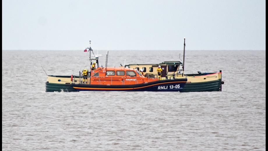 Lowestoft RNLI lifeboat alongside the former tug 
