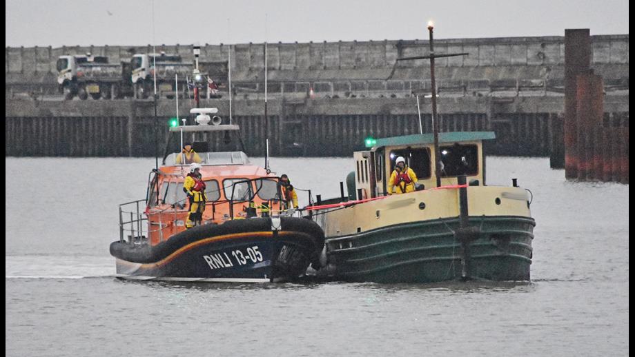 Lowestoft RNLI lifeboat brings the former tug into Lowestoft Harbour