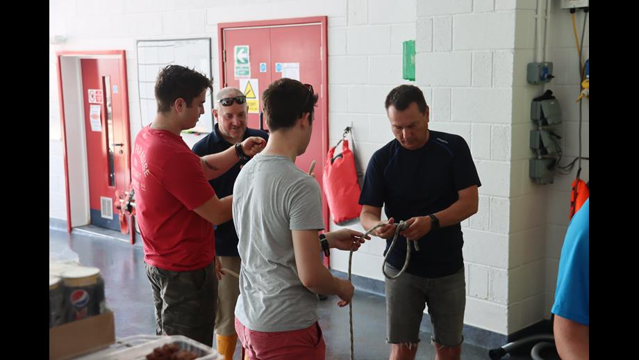 Bruce teaching new crew volunteers how to tie knots with Dave. Left to right, Cameron, Dave, Matt and Bruce