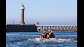 the inshore lifeboat leaving Whitby harbour