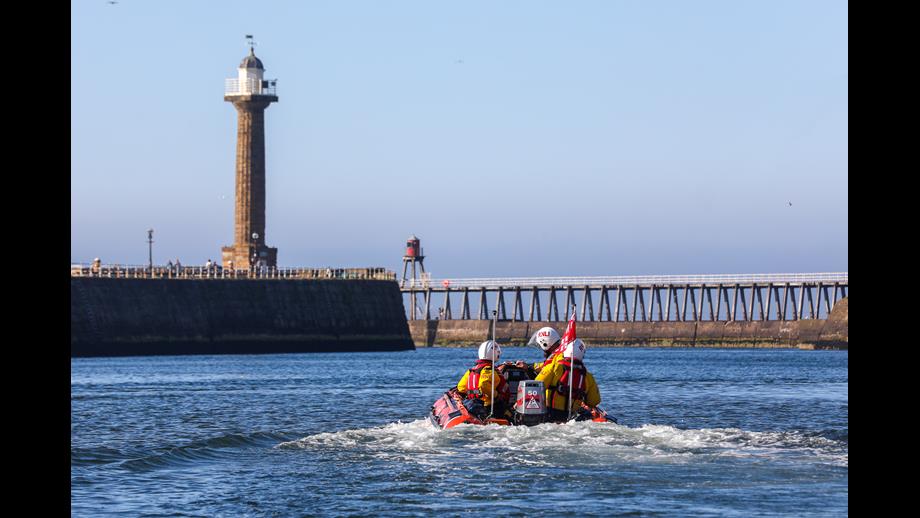 the inshore lifeboat leaving Whitby harbour