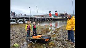 Junior raft race winners with their craft, and the PS Waverley in the background
