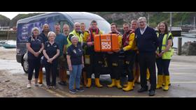 Group shot of Stonehaven RNLI volunteer crew and fundraisers with the 200th Anniversary scroll