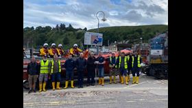 Stonehaven RNLI volunteer crew photographed in front of Atlantic 85 with Jim Smith presenting his donation