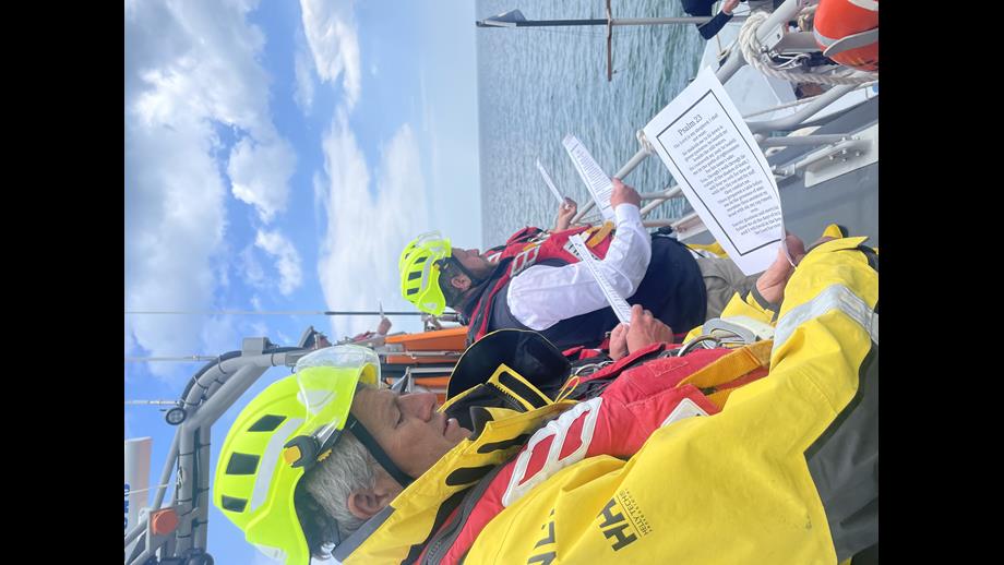 Crew reading from a sheet of paper 