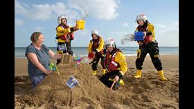 Local artist and Wexford woman Helen Mason is joined by volunteer lifeboat crew from Fethard RNLI to launch Be by the Sea. LtoR: Michael Cooper, Helen Mason, Clara Bracken, Paddy O'Regan and Trica Rice (mother with child in background, Justine MacNamara with her son Rory Haynes).