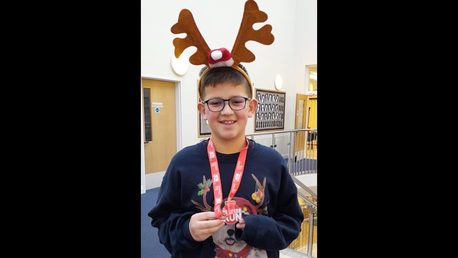 George Clark with his Reindeer Run Challenge medal