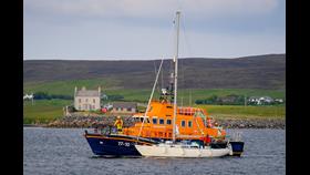 Lerwick lifeboat with the yacht on its port side. 