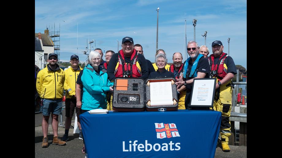 Eyemouth RNLI fundraisers and crew with the historic RNLI 200th anniversary scroll