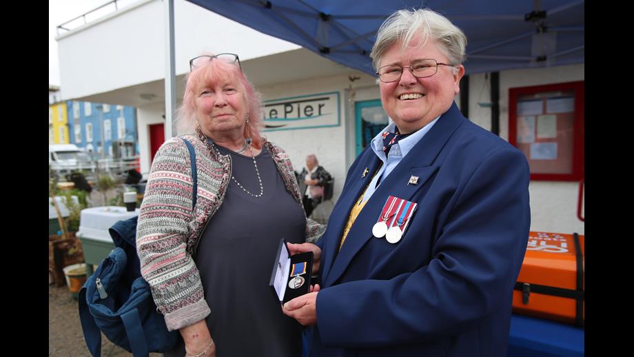 Tobermory RNLI Lifeboat Operations Manager Dr Sam Jones presents Andi Stevens with Ian Stevens' long service medal