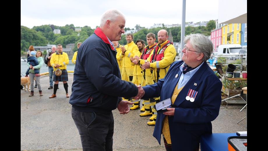 Tobermory RNLI Lifeboat Operations Manager Dr Sam Jones presents Ian Elwis with long service medal