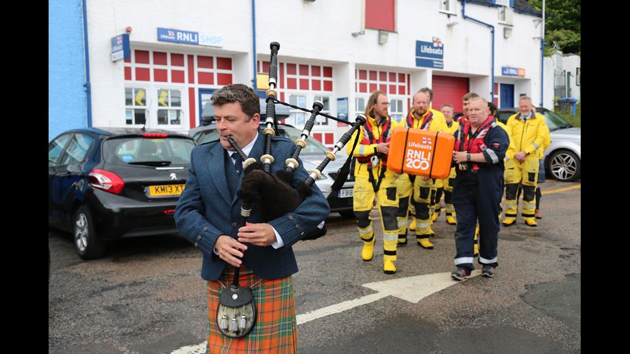 Piper Calum MacLean leads the RNLI 200 Scroll and crew