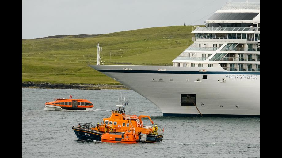 The former offshore lifeboat was taken alongside Lerwick Lifeboat, to pass through a busy harbour near a visiting cruise ship.