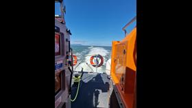 A white vessel on the sea with blue sky
