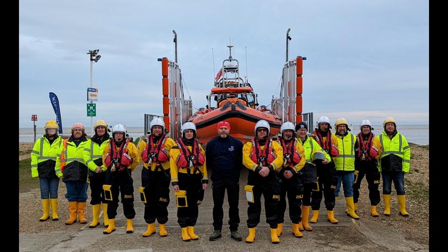 Littlestone crew member gather for a photo infront of the charity lifeboat