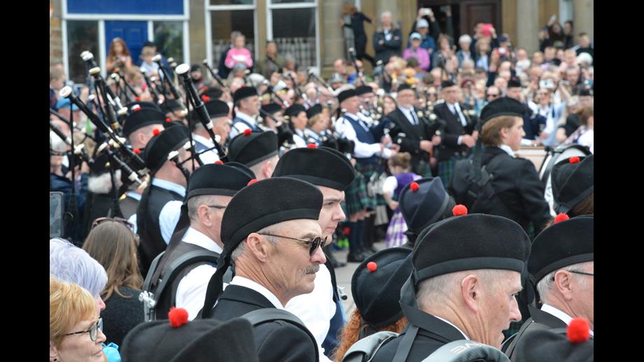 The band surrounded by a massed croud at the Pier Head