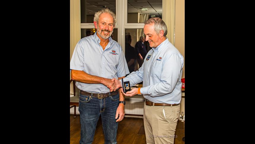 Stuart Cross accepting a long service medal at an awards ceremony last year.