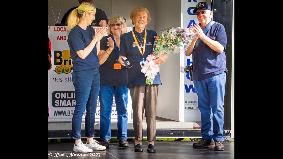 Margaret Sharp at Lifeboat Summer gala last year being presented with her long service medal and bouquet of flowers.