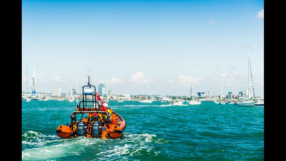 Portsmouth RNLI's Atlantic 85 during a sailing race with the spinnaker tower in the background