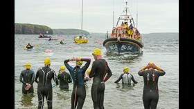 Swimmers prepare for action with Dunmore East RNLI All Weather Lifeboat in the background