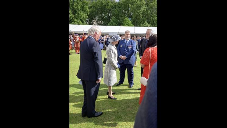 The Princess Royal standing on the lawn speaking with Scott Vardy and others