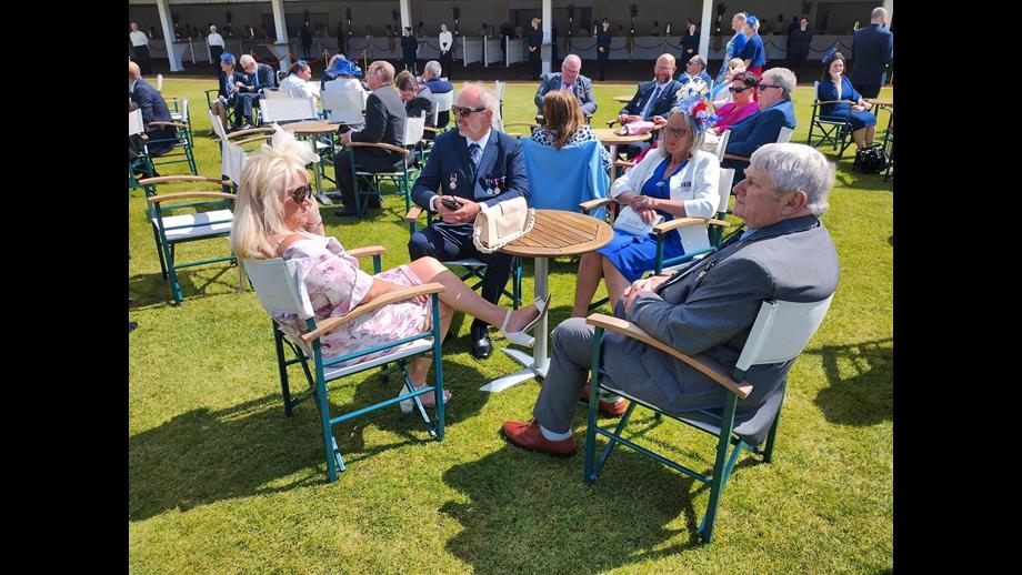 David Freeman, Diane Cross, Stuart Cross and Anita Vardy sitting at a table on the lawn of Buckingham Palace.