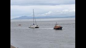 Shannon Class lifeboat Kenneth James Pierpoint ahead, a catamaran under tow and D Class ILB Harbet trailing.