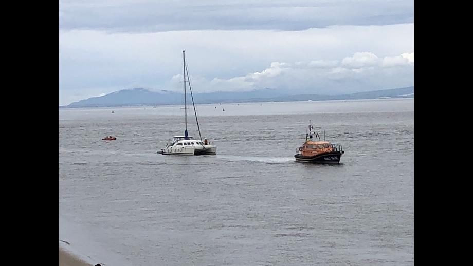 Shannon Class lifeboat Kenneth James Pierpoint ahead, a catamaran under tow and D Class ILB Harbet trailing.