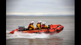 RNLI Inshore Lifeboat D-853 Harbet making way, with spray emanating from about halfway along the hull
