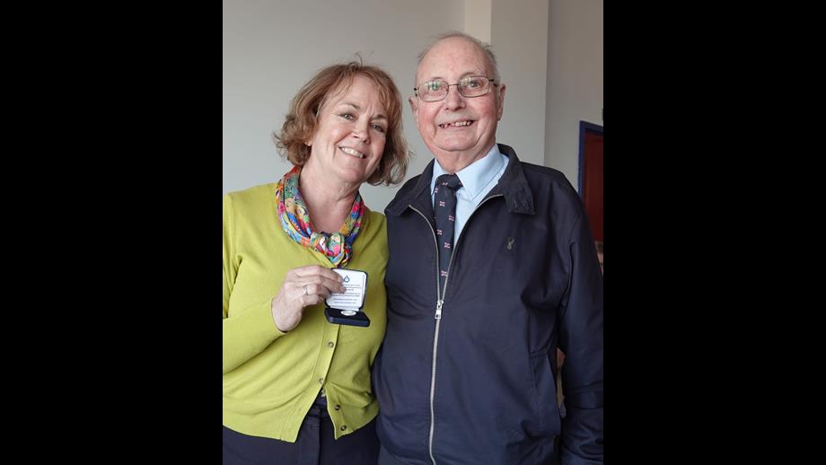 Jayne presenting Ken with an award for long service