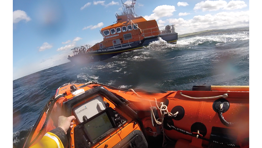 Two lifeboats at sea.