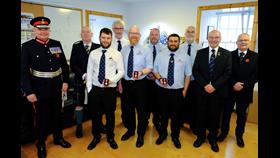 Group photo of lifeboat crew with Coronation Medals - Lord Lieutenant Lindsay Tulloch (left) with John Best, Coxswain Stephen Manson, Peter Kerr, Ryan Leith, Kenneth Couper, Nathan Mann, Malcolm Craigie, accompanied by Vice Lieutenant Iain Tulloch and RNLI Lerwick Branch Chair John Webster.