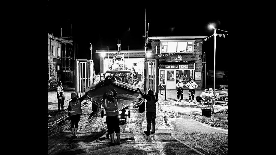 A black and white picture of the lifeboat being readied for service after a shout at night