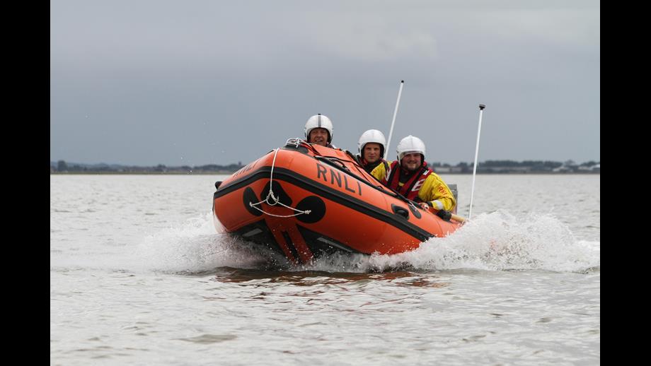 An Inshore Lifeboat (ILB) with three crew on board heads towards the camera