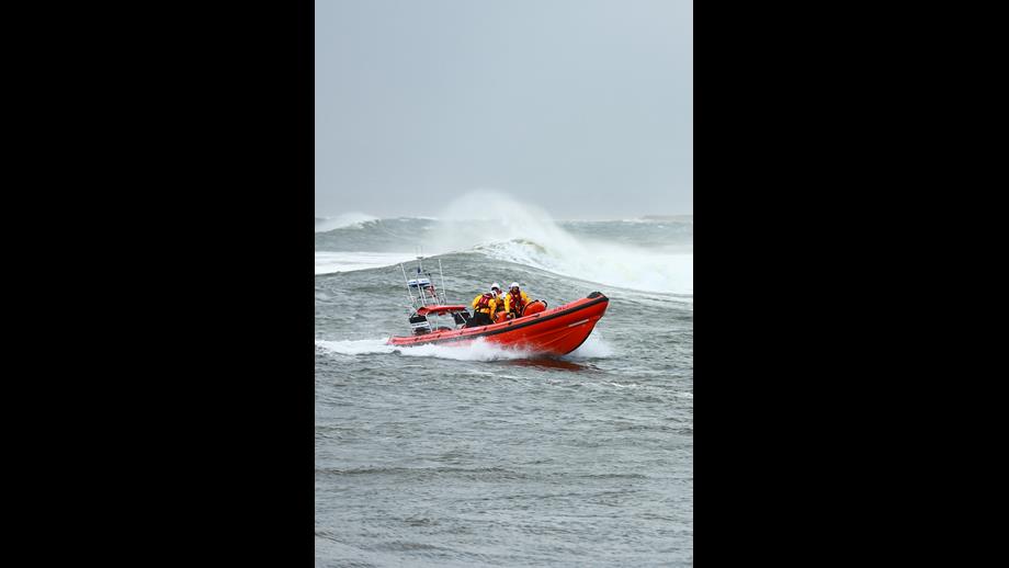 Bundoran RNLI assisting the swimmer rescued from the water.